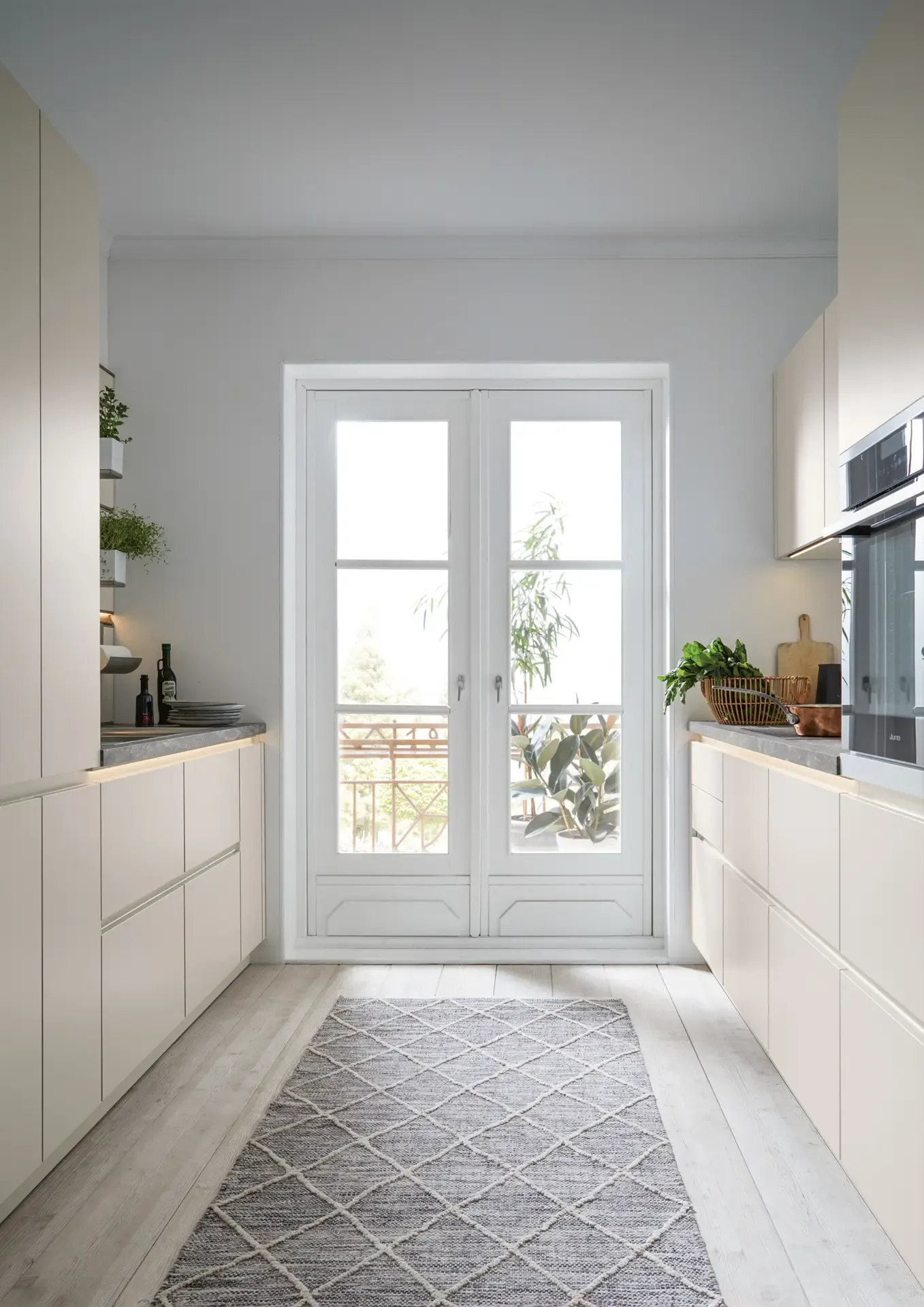 Moderne helle Küche in Muschelweiß, Raumansicht bei Tageslicht